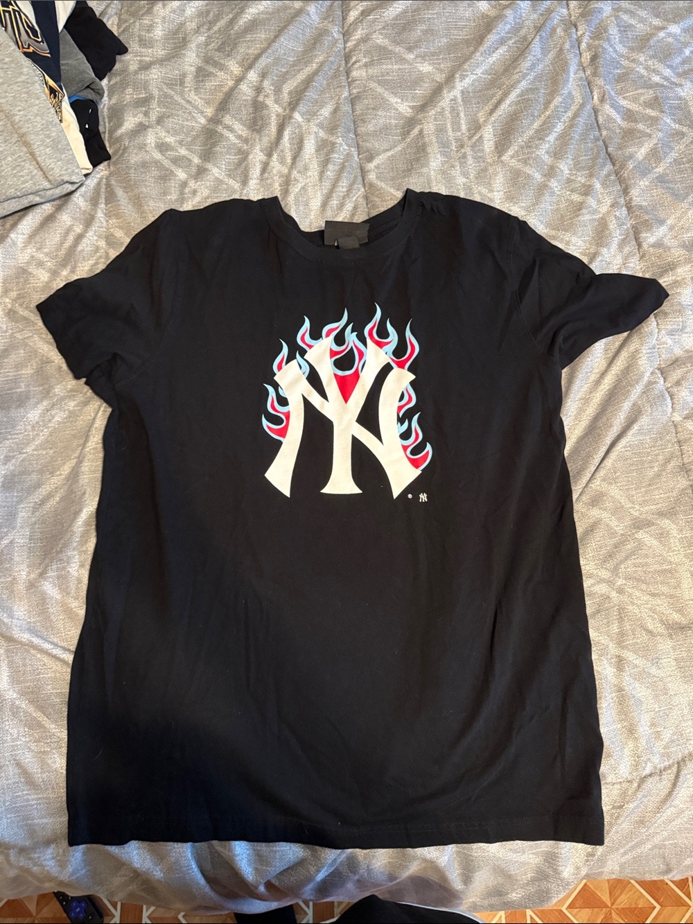 New Era Black Kids T‑Shirt with White NY Flame Logo and Blue/Red Accent